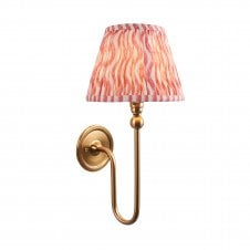 brass wall light with pink ripple pattern shade