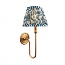 brass wall light with blue ripple pattern shade