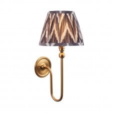 brass wall light with grey zigzag pattern shade