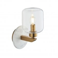 modern wall light in a brass finish with white marble backplate with clear glass shade